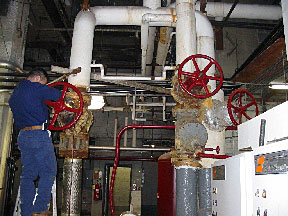 Contractor cleaning a boiler in our service area: Essex, Hudson, Union, Bergen, Morris, Passaic, Somerset, and Middlesex Counties in NJ.